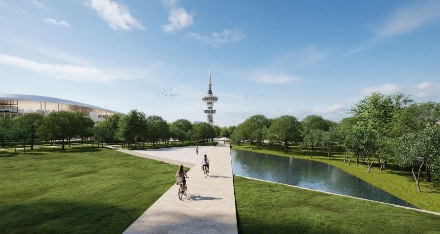 Pedestrians and cyclists on a path through the new Metropolitan Park with the OTE Tower in the background
