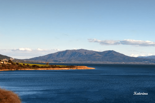 Lake Volvi with its blue waters and the surrounding mountain landscape under a clear sky
