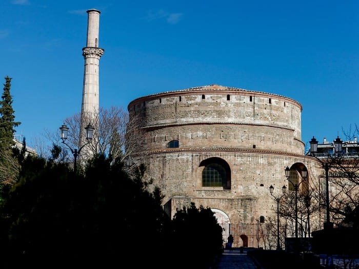 The Rotunda of Thessaloniki, a massive circular stone structure with a tall minaret standing beside it