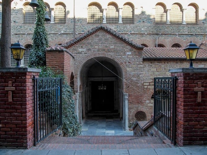 Arched stone entrance and brick facade of the Church of Panagia Achiropoiitou