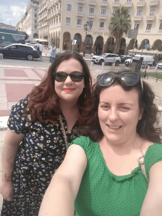 Two women smiling while taking a selfie during a walking tour in Thessaloniki
