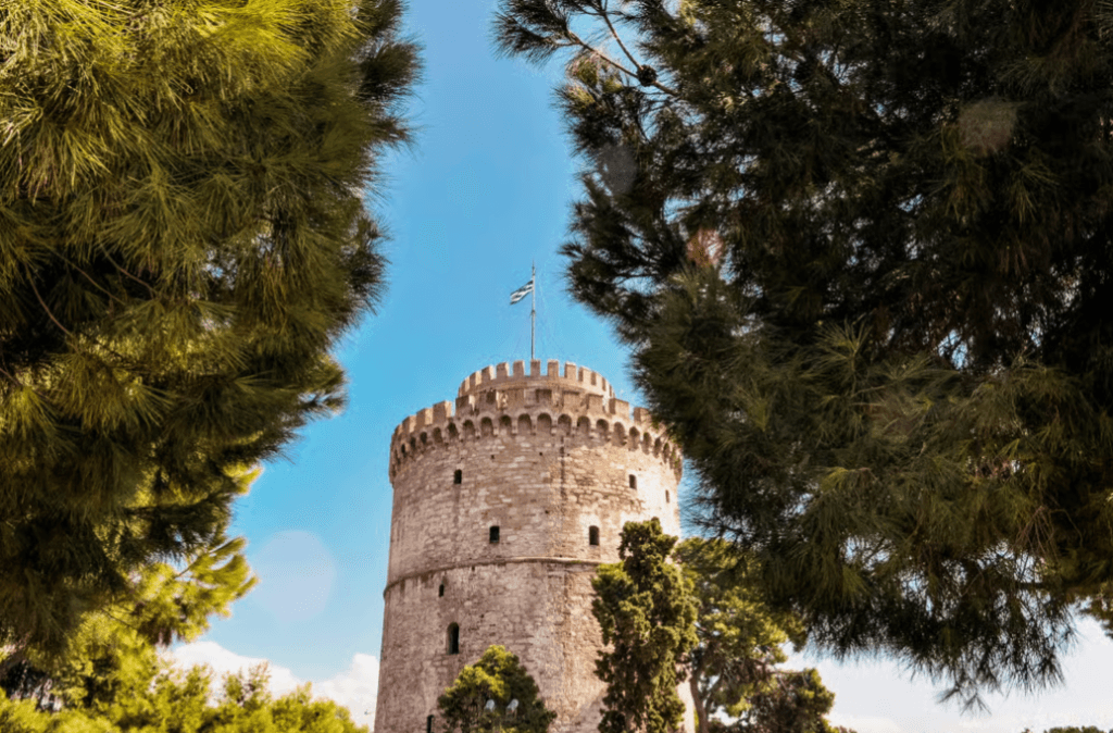 The White Tower of Thessaloniki framed by pine trees