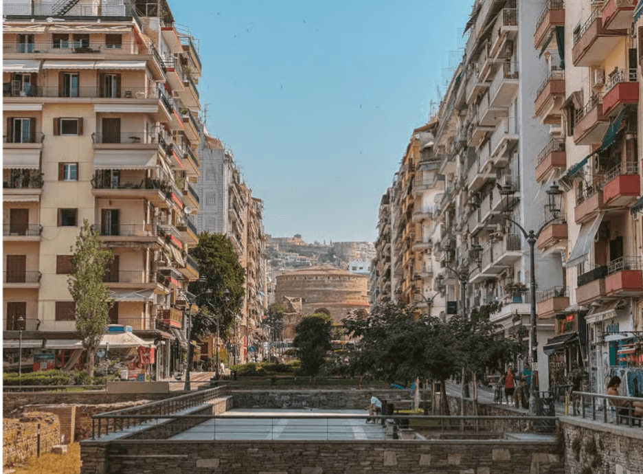 A Thessaloniki street lined with apartment buildings leading toward the ancient Rotunda of Galerius