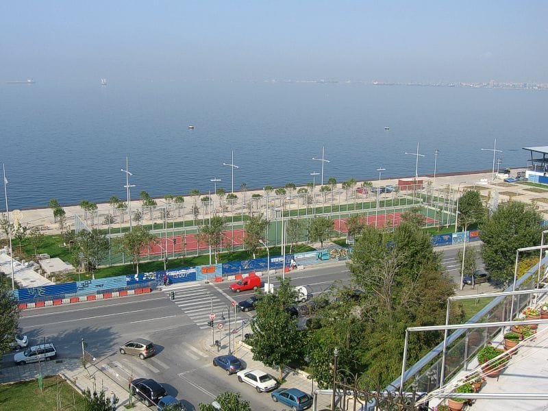 Sports courts in the Garden of Remembrance along the Thessaloniki beachfront, with the sea in the background